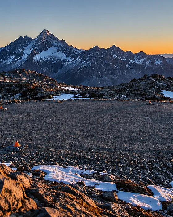 Rocky high plateau with a cleared landing area at sunrise